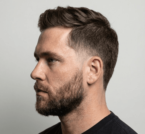 Low Taper Burst Fade small semicircular fade around ears dynamic style, round wide faces curly afro hair sport street style